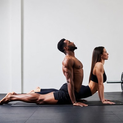 Black man and woman doing cobra pose