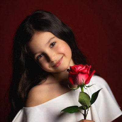 Girl holding red rose