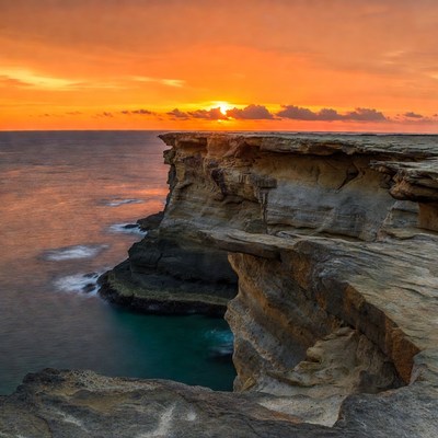 Sunset over ocean cliffs