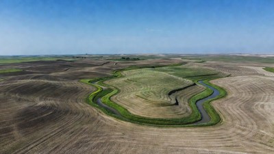 Aerial view of winding river in farmland