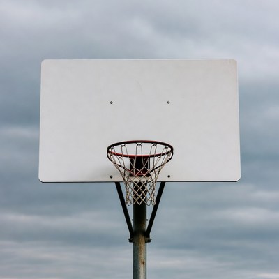 Basketball hoop on cloudy sky