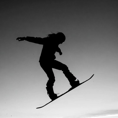 Woman snowboarding silhouette jump