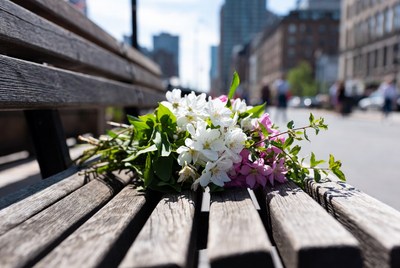 Bouquet of white and pink flowers on park bench