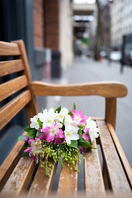 Bouquet of white pink orchids on park bench