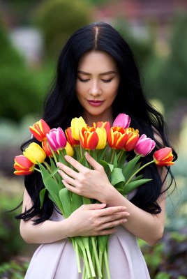 Asian woman holding colorful tulips