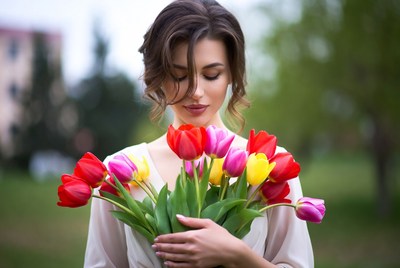Woman holding colorful tulips