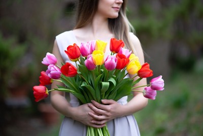 Woman holding colorful tulips bouquet