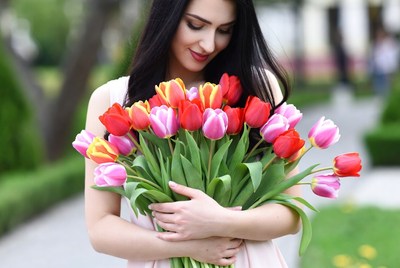 Woman holding colorful tulips bouquet