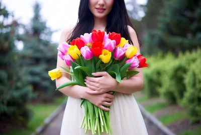 Asian woman holding colorful tulips