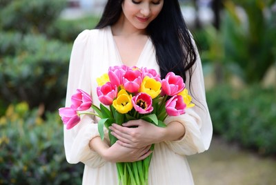 Asian woman holding tulips