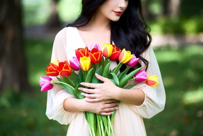 Asian woman holding colorful tulips