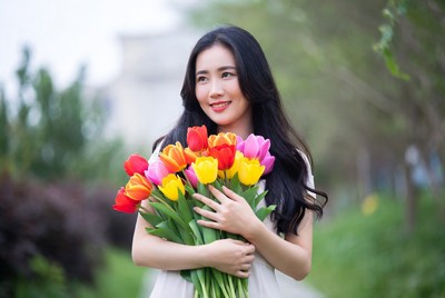 Asian woman holding colorful tulips