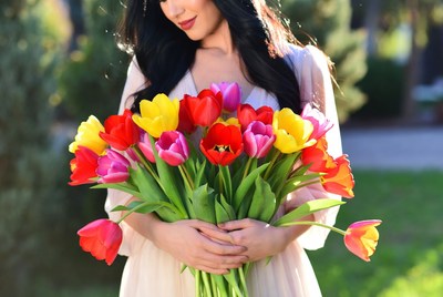 Woman holding colorful tulips