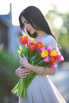 Asian woman holding colorful tulips