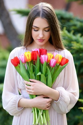 Woman holding colorful tulips