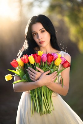Woman holding colorful tulips outdoors
