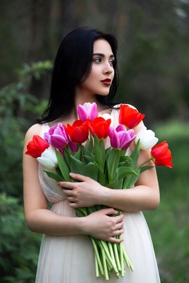 Woman holding colorful tulips