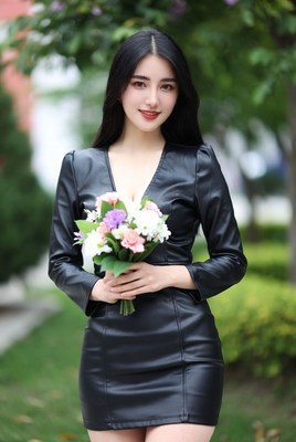 Asian woman holding flowers in black leather dress