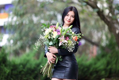 Asian woman holding colorful bouquet