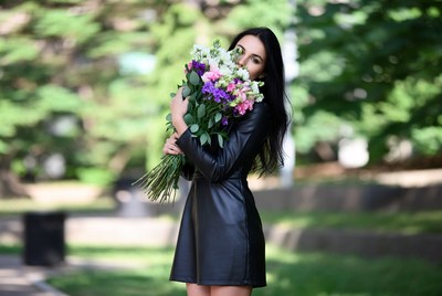Woman holding colorful bouquet outdoors