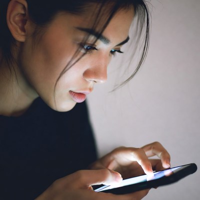 Asian woman using phone at night