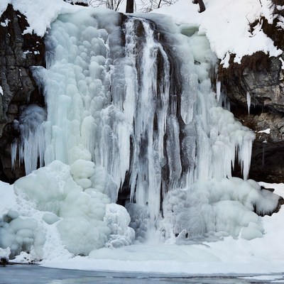 Frozen Waterfall in Snowy Landscape