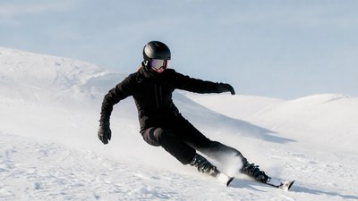 Woman skiing down snowy slope
