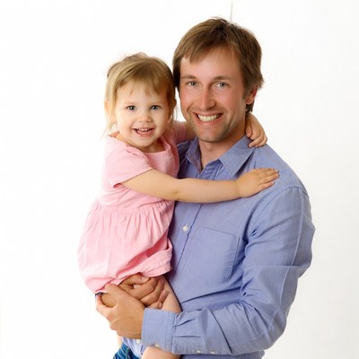 Father holding smiling daughter