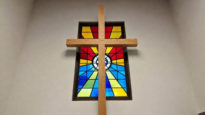 Wooden Cross Over Colorful Stained Glass Window