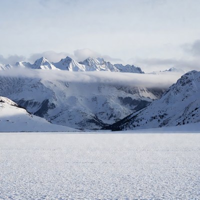 Snowy Mountains Over Frozen Lake