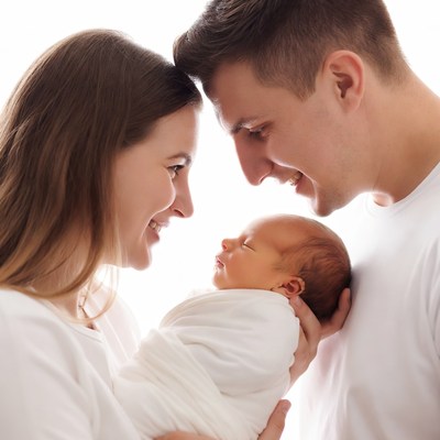 Parents gazing at newborn baby