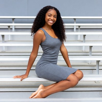 Smiling African-American woman on bleachers