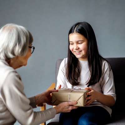 Grandmother giving girl gift