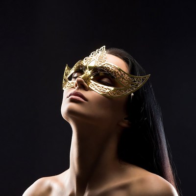 Woman wearing gold masquerade mask