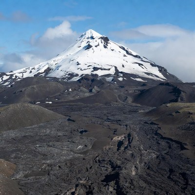 Snow-capped volcano with lava fields