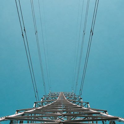 Power Lines Tower Against Blue Sky