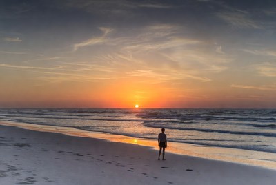 Silhouette of woman at sunset beach