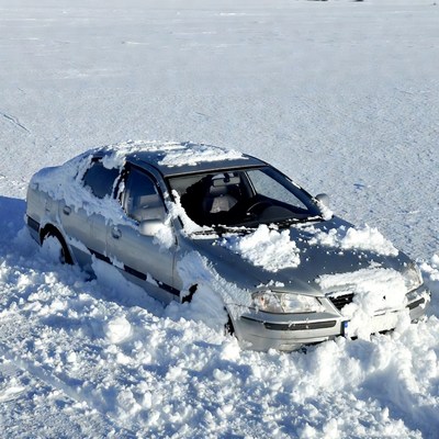 Silver car stuck in deep snow