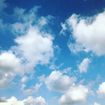 Fluffy white clouds in blue sky