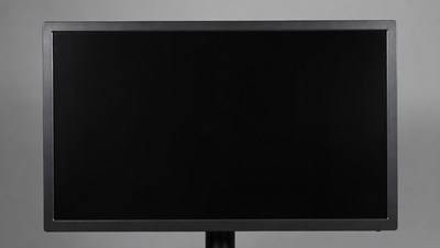 Black computer monitor on gray background