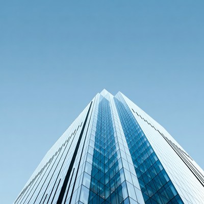 Modern Glass Skyscraper Against Blue Sky