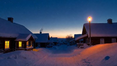 Snowy Wooden Cabins at Night