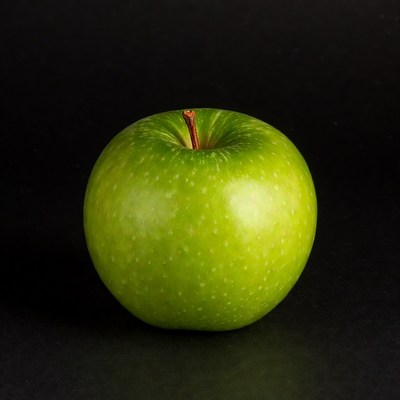 Green apple on black background