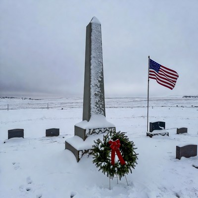 Snowy Obelisk Monument with American Flag