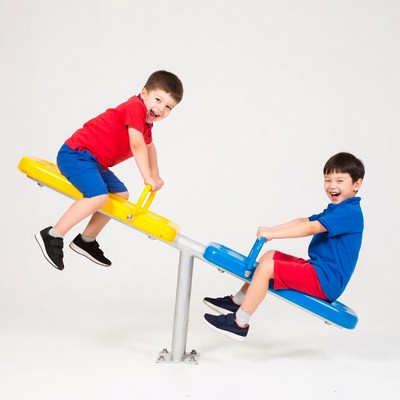 Two boys playing on seesaw