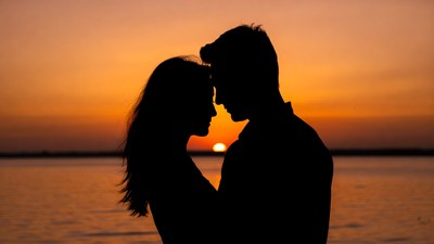 Silhouette couple embracing at sunset