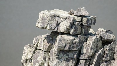 Stacked Gray Rocks on Cliff Edge