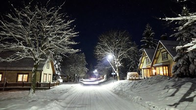 Snowy Street with Houses at Night