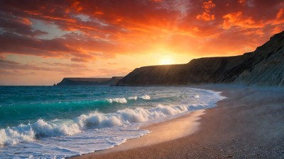 Sunset over beach with cliffs