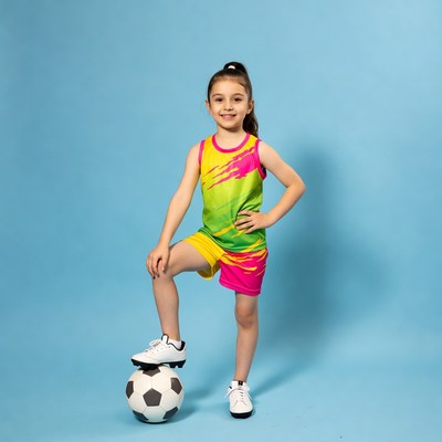 Girl standing on soccer ball